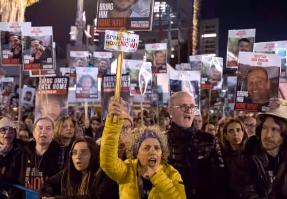 'Israeli' protesters hold signs and photos of captives during a rally calling for their release in Tel Aviv on February 3, 2015. Photo: Getty Images.