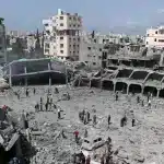 Palestinians inspect damage to a school in Gaza where displaced people shelter, after it devastated by an Israeli strike, April 4, 2025. File photo.