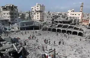 Palestinians inspect damage to a school in Gaza where displaced people shelter, after it devastated by an Israeli strike, April 4, 2025. File photo.