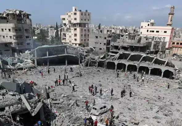 Palestinians inspect damage to a school in Gaza where displaced people shelter, after it devastated by an Israeli strike, April 4, 2025. File photo.