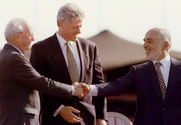 Prime ministers Yitzhak Rabin and US president Bill Clinton congratulate Jordan’s King Hussein after his speech at the Israeli-Jordanian peace treaty signing ceremony on October 26, 1994. Photo: Gary Hershorn/file photo.
