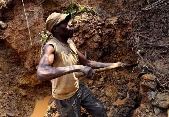 One of the few remaining miners digs out soil which will later be filtered for traces of cassiterite, the major ore on tin, at Nyabibwe mine, in eastern Congo, on August 17, 2012. Photo: AP.