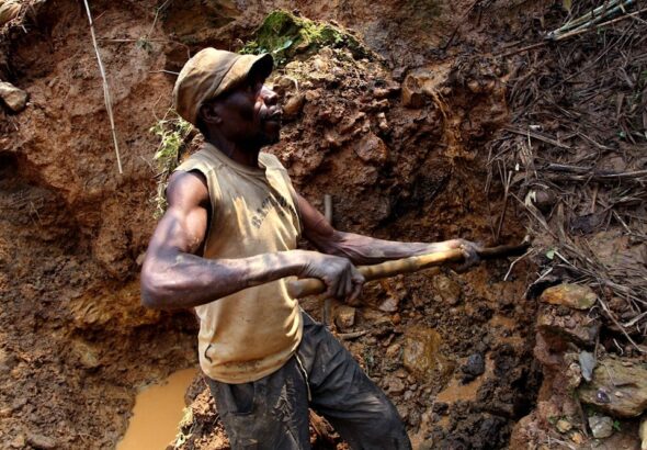 One of the few remaining miners digs out soil which will later be filtered for traces of cassiterite, the major ore on tin, at Nyabibwe mine, in eastern Congo, on August 17, 2012. Photo: AP.