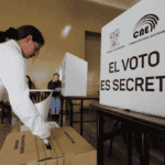 A voter deposits her ballot in a polling station in Ecuador. File photo.