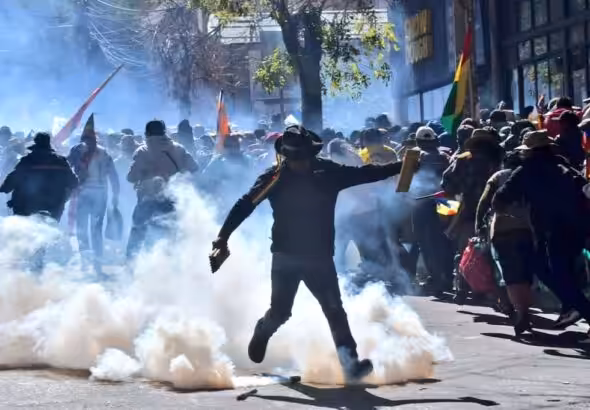 An Evo Morales supporter kicks a tear gas canister used by Bolivian police to repress those supporting Evo Morales registrations as candidate for the upcoming presidential elections. La Paz, Bolivia, on May 16, 2025. Photo: X/@evoespueblo.