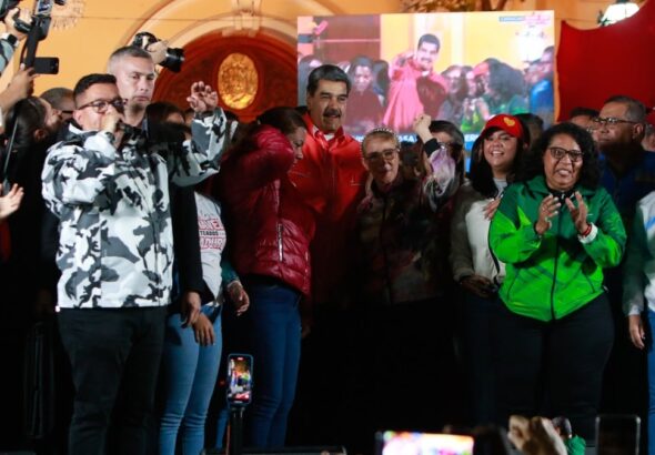 President of Venezuela, Nicolás Maduro, is observed surrounded by supporters, celebrating the election of governors and deputies at a government event early Monday, in Caracas, Venezuela. Photo: Presidential Press.