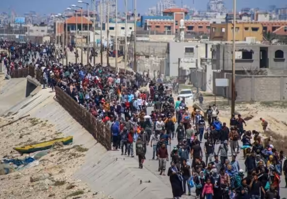 Palestinians wait for aid trucks to cross in the central Gaza Strip on May 19, 2024. Photo: Bloomberg.