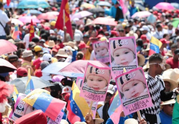 Marchers holding posters with the photo of the Venezuelan baby girl Maikelys Espinoza, who was kidnapped by US authorities, during the May Day march in Caracas on May 1, 2025. Photo: Alma Plus TV.