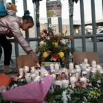 A girl lights a candle at a vigil for the victims of a fire at a migrant shelter that killed dozens in Ciudad Juárez, Mexico, on March 28, 2023. Photo: Christian Chavez/AP/file photo.
