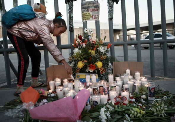 A girl lights a candle at a vigil for the victims of a fire at a migrant shelter that killed dozens in Ciudad Juárez, Mexico, on March 28, 2023. Photo: Christian Chavez/AP/file photo.