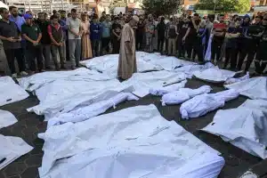 Covered bodies of Palestinians killed in a November 2023 airstrike in Deir al-Balah, Gaza. Photo: Mahmud Hams/AFP/Getty Images.