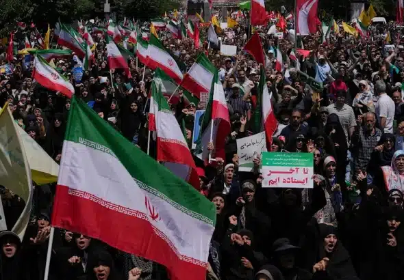 Iranian worshipers carry their county's flags in a protest to condemn Israeli on multiple cities across Iran, after the Friday prayers ceremony in Tehran, Iran, Friday, June 20, 2025. Photo: AP.