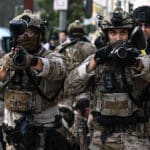 US Customs and Border Protection agents hold up "less-lethal" weapons in front of the Federal Building during ongoing demonstrations in response to federal immigration operations in downtown Los Angeles on June 12, 2025. Photo: Ronaldo Schemidt/ AFP/Getty Images.