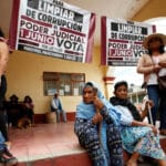 People around banners in support of the June 1 judicial elections in Mexico. Photo: France24.