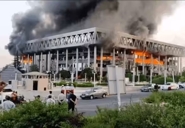 Smoke pours out of the building of Iran's national broadcaster after it was targeted by the Zionist entity. Photo: IRIB.