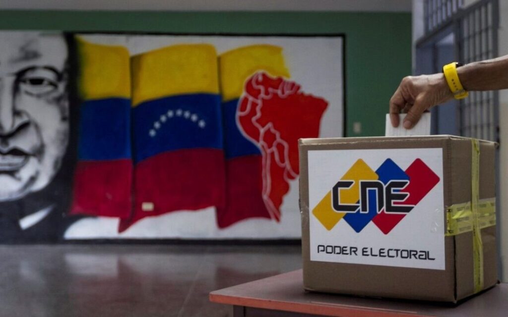 A person inserts a ballot into a ballot box bearing CNE logo. Photo: AVN.