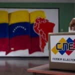 A person inserts a ballot into a ballot box bearing CNE logo. Photo: AVN.
