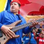 Late Venezuelan President Hugo Chávez holding an electric guitar during a political rally. Photo: File photo.