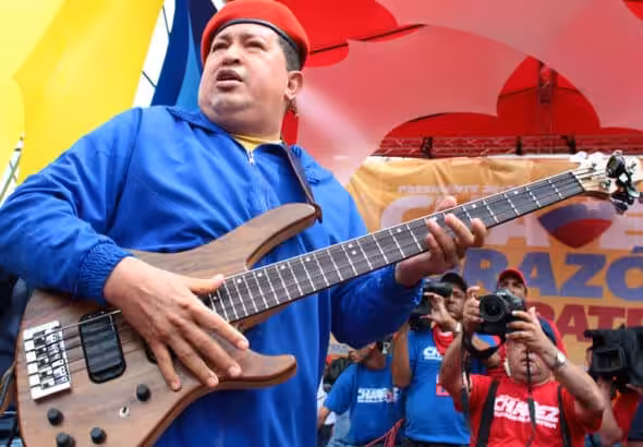 Late Venezuelan President Hugo Chávez holding an electric guitar during a political rally. Photo: File photo.