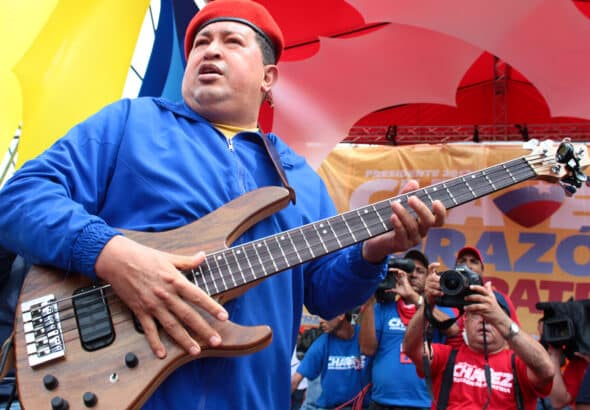 Late Venezuelan President Hugo Chávez holding an electric guitar during a political rally. Photo: File photo.