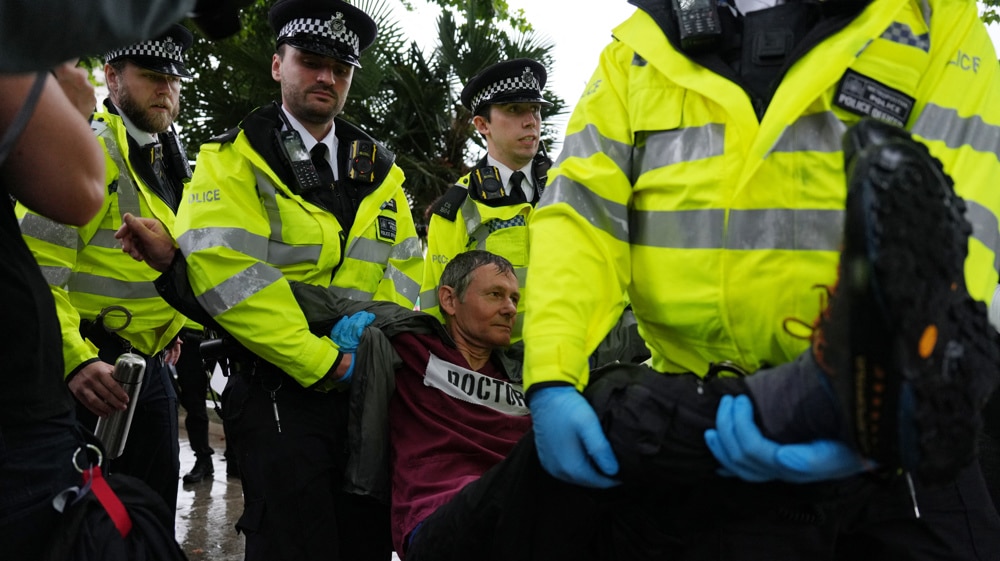 A protester is carried away by police officers at a rally in support of Palestine Action in Parliament Square, central London, on July 19, 2025. Photo: Carlos Jasso/AFP.