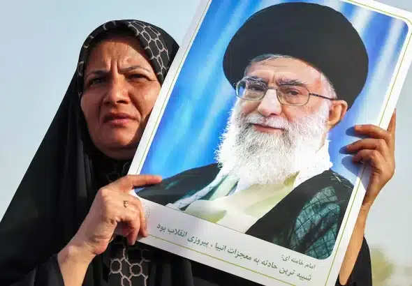 An Iranian woman holds a portrait of supreme leader Ayatollah Ali Khamenei. Photo: Atta Kenare/AFP.
