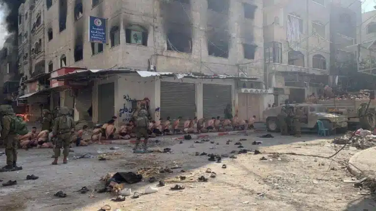 Dozens of Palestinian men being kidnapped by the 'Israeli military,' many stripped down to their underwear, in the streets of a city in northern Gaza on December 7, 2023. Photo: Social media.