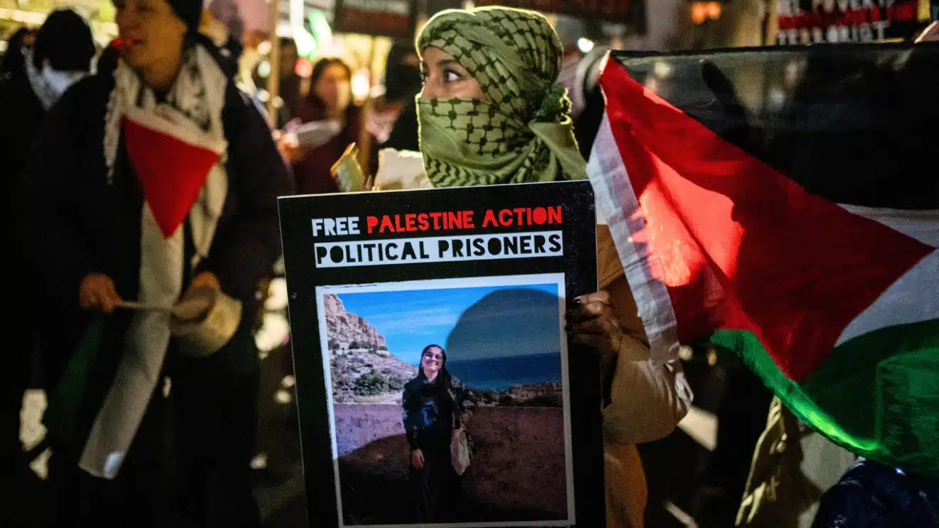 A protestor holds a placard during the demonstration. Hundreds of Palestine Action protestors congregated at HMP Brixton Prison to lobby for the release of all Political Prisoners on their annual New Year’s Eve “Noise Demo”. Photo: Lab Ky Mo/Sipa/AP Images