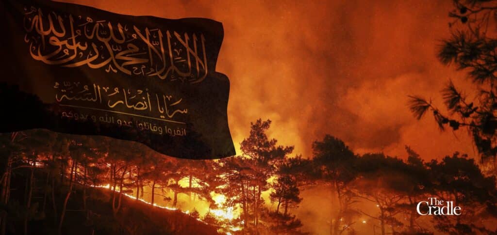Image composition featuring flag of Saraya Ansar al-Sunnah flying in the foreground with a wildfire burning in the background. Photo: The Cradle.