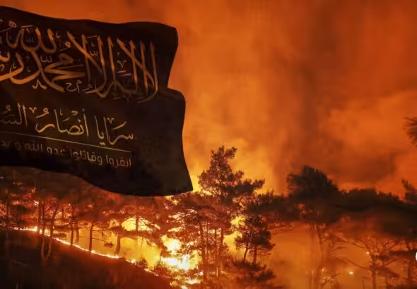 Image composition featuring flag of Saraya Ansar al-Sunnah flying in the foreground with a wildfire burning in the background. Photo: The Cradle.