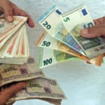People hold Cuban peso, US dollar, and euro notes. Photo: EFE/Ernesto Mastrascusa.
