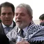 Brazilian President Luiz Inácio Lula da Silva, wearing a keffiyeh, speaks with a Palestinian official after inaugurating Brazil Street alongside Palestinian Prime Minister Salam Fayyad (right), outside the Palestinian Authority headquarters in the Israeli-occupied West Bank city of Ramallah on March 17, 2010. Photo: Marina Passos/AFP/File photo.