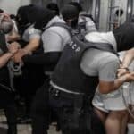 Prisoners, bound hands and feet, being dragged by guards in the Salvadoran mega-prison CECOT, where the Trump administration illegally transferred Venezuelan migrants. Photo: Government of El Salvador.