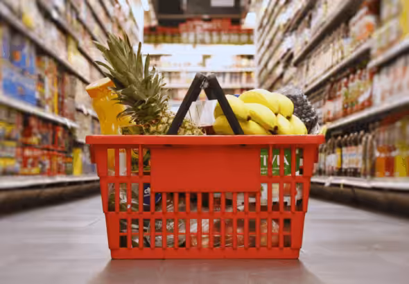 Grocery hand basket on a grocery store isle. File photo.