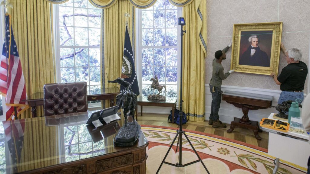Workers handle a portrait of former US President Andrew Jackson for a replica of the Trump administration's Oval Office. Photo: AP/Rod Lamkey.