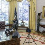 Workers handle a portrait of former US President Andrew Jackson for a replica of the Trump administration's Oval Office. Photo: AP/Rod Lamkey.
