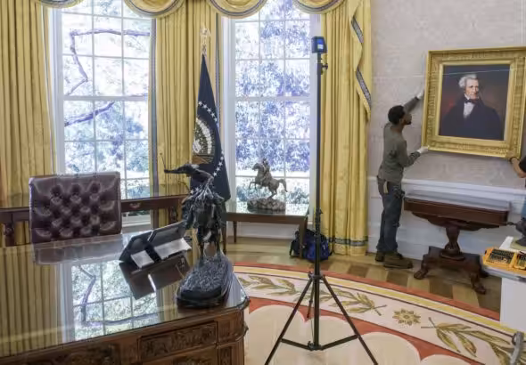 Workers handle a portrait of former US President Andrew Jackson for a replica of the Trump administration's Oval Office. Photo: AP/Rod Lamkey.