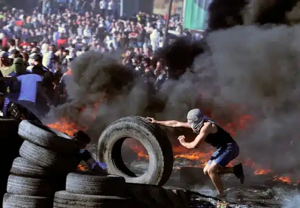 Palestinian protesters confront Israeli troops at the Hawara checkpoint south of Nablus city in the occupied West Bank, during a demonstration in support of those under bombardment in Gaza, in May, 2021. Photo: Jaafar Ashtiyeh/AFP.