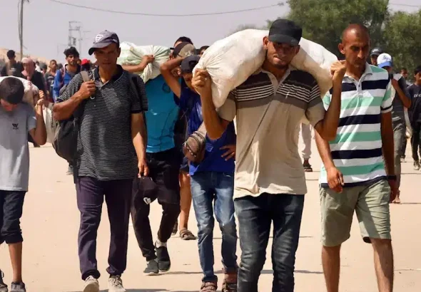 Palestinians carry humanitarian aid they received through the Rafah corridor in the southern Gaza Strip on July 28, 2025. Photo: AFP.