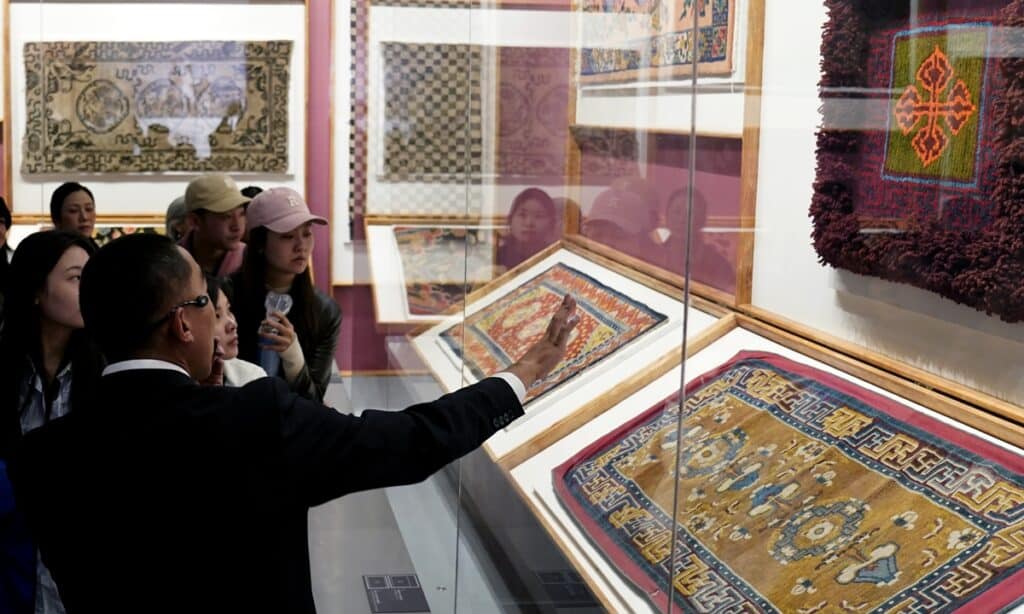 Visitors view Tibetan carpets on display at the Xizang Museum in Lhasa on October 19, 2024. Photo: VCG.