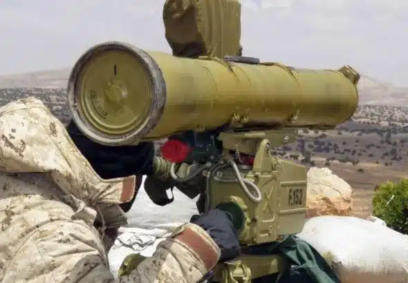 A handout picture released by the Hezbollah press office on May 13, 2015, shows a Hezbollah fighter aiming his weapon on the Syrian side of the Qalamun hills close to the Lebanese border. Photo: AFP Photo/Hezbollah press office.