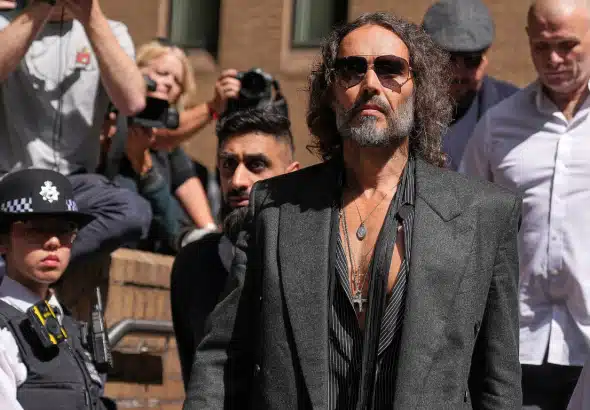 English comedian and actor Russell Brand leaves Southwark Crown Court where he is charged with rape and sexual assault in London, Friday, May 30, 2025. Photo: Alastair Grant/AP Photo.