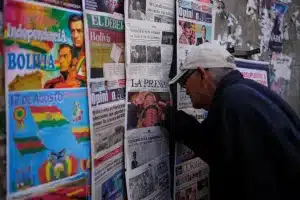 A man looks at newspapers front pages the day after presidential and legislative elections in La Paz, Bolivia. Photo: The Morning Star Shop.