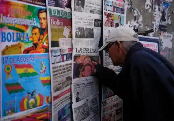 A man looks at newspapers front pages the day after presidential and legislative elections in La Paz, Bolivia. Photo: The Morning Star Shop.