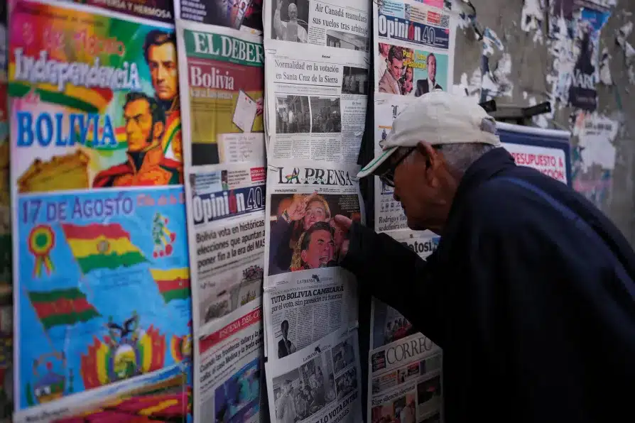 A man looks at newspapers front pages the day after presidential and legislative elections in La Paz, Bolivia. Photo: The Morning Star Shop.