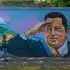 A woman walks past a mural of Hugo Chavez in Caracas, Venezuela, May 29, 2022. Photo: Jimmy Villalta/ZUMA Press Wire/Legion-Media.