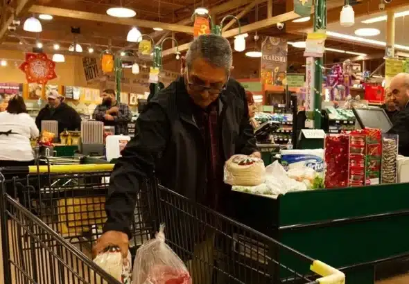 A customer puts the groceries he bought from the Northgate supermarket in a cart. Photo: Felipe Chacón/EFE.