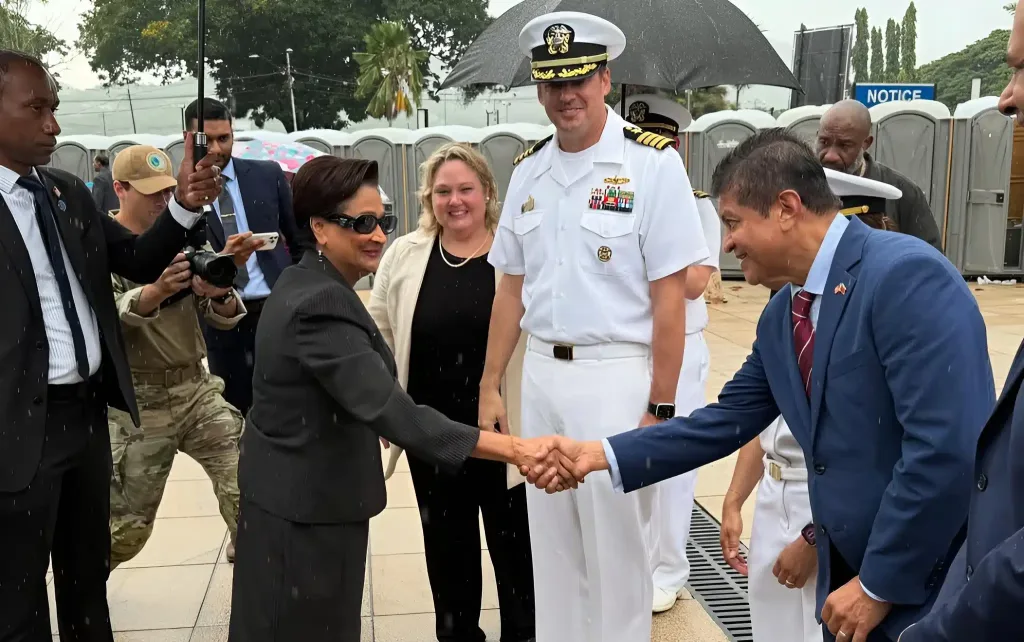 Kamla Persad-Bissessar, prime minister of Trinidad and Tobago, shaking hands with Lackram Bodoe, Minister of Health, while being greeted by US Navy officials during a visit to the hospital ship USNS Comfort, docked at the Port of Port-of-Spain on August 7, 2025. Photo: IG/@minhealthtt.
