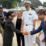 Kamla Persad-Bissessar, prime minister of Trinidad and Tobago, shaking hands with Lackram Bodoe, Minister of Health, while being greeted by US Navy officials during a visit to the hospital ship USNS Comfort, docked at the Port of Port-of-Spain on August 7, 2025. Photo: IG/@minhealthtt.