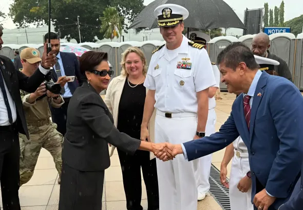 Kamla Persad-Bissessar, prime minister of Trinidad and Tobago, shaking hands with Lackram Bodoe, Minister of Health, while being greeted by US Navy officials during a visit to the hospital ship USNS Comfort, docked at the Port of Port-of-Spain on August 7, 2025. Photo: IG/@minhealthtt.
